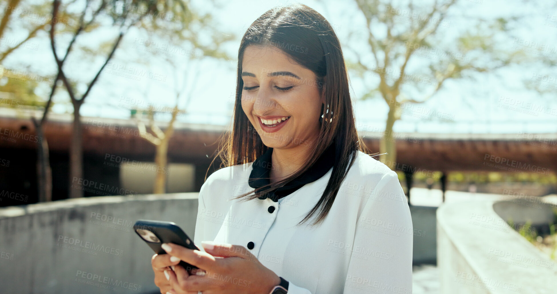 Buy stock photo Business woman, phone and happy in city, park and click on mobile app, notification or chat on web. Person, smartphone and smile with travel, funny video or post on social media on break in Colombia