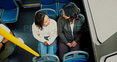 Buy stock photo Travel, above and mother with daughter in bus for commute, support and bonding together. Public transportation, conversation and shuttle service with woman and girl for metro, chat and family trip