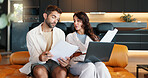 Home, documents and couple with laptop, conversation and planning for savings. Budget, apartment and man with woman on sofa, paperwork and computer with discussion, tax report and asset management