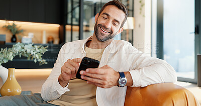 Buy stock photo Home, funny and man on sofa, smartphone and smile with message to contact, chatting and connection. Person, social media and guy with cellphone and internet with meme, humor or email notification