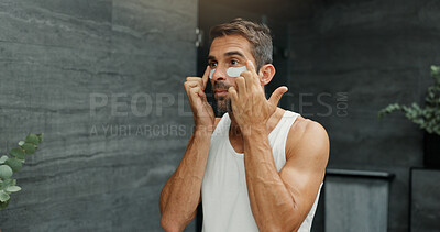 Buy stock photo Beauty, dermatology and eye mask with man in bathroom of home for antiaging cosmetics or wellness. Application, cosmetology and facial product with person in apartment for morning skincare routine