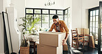 New house, moving and man with boxes, real estate and ownership of property with mortgage or lounge. Relocation, buyer and person with cardboard in living room, investment and purchase with home loan