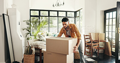 Buy stock photo New house, moving and man with boxes, real estate and ownership of property with mortgage or lounge. Relocation, buyer and person with cardboard in living room, investment and purchase with home loan