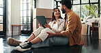Tablet, happy and couple in new home with planning for renovation, development or moving. Cardboard boxes, real estate and man with woman on digital technology for online order in apartment.