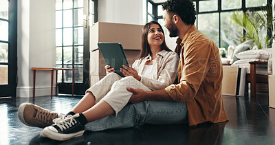 Buy stock photo Tablet, happy and couple in new home with planning for renovation, development or moving. Cardboard boxes, real estate and man with woman on digital technology for online order in apartment.