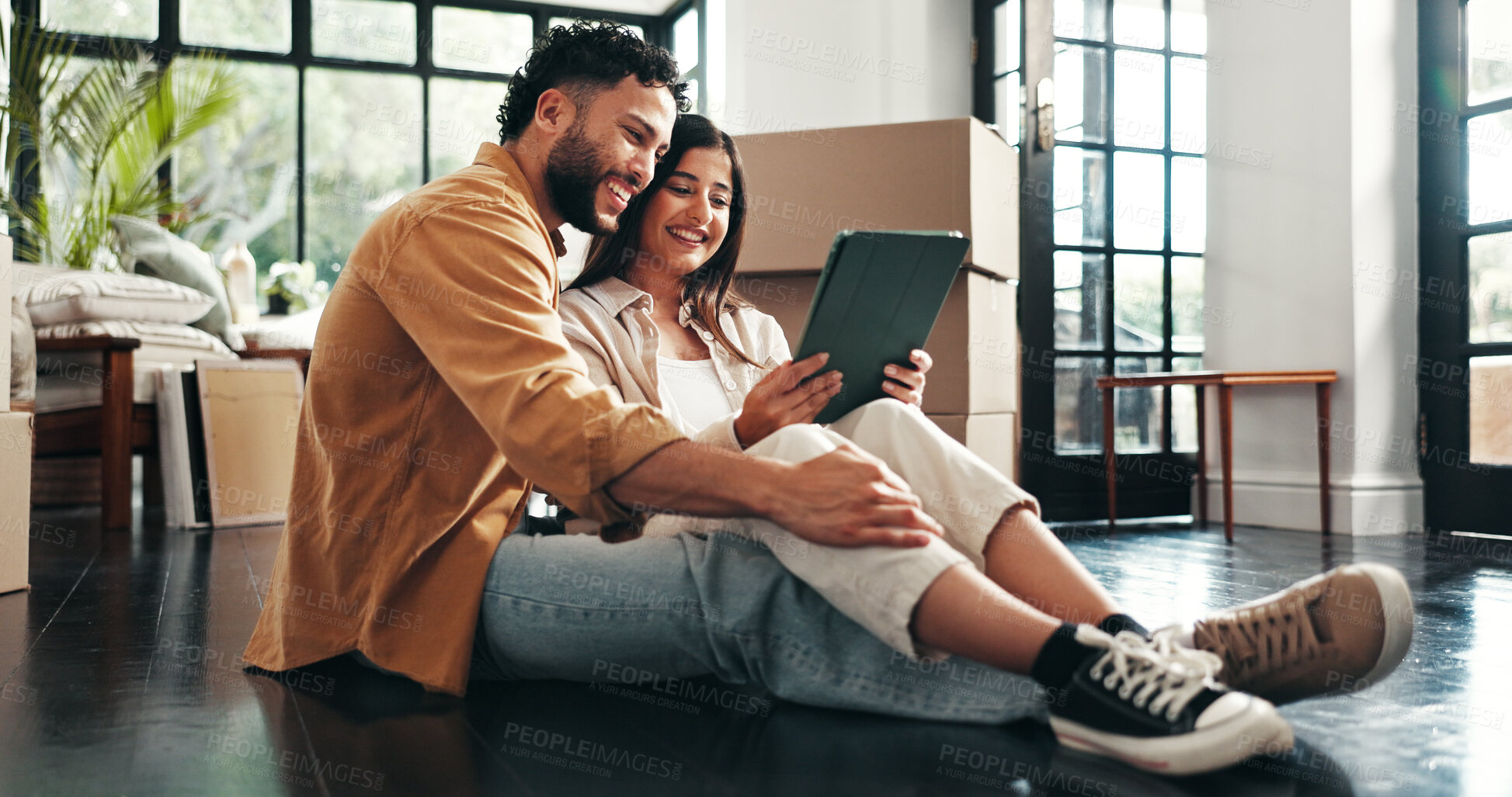 Buy stock photo Smile, couple and floor on tablet at new house for research, online shopping and furniture purchase. Happy, people and boxes with digital for real estate, interior design and choice on decor for home