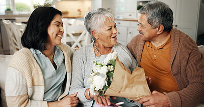 Buy stock photo Birthday, flowers or gift with family on sofa in living room of home together for bonding or celebration. Bouquet, love or present with senior parents and daughter in apartment for event or milestone