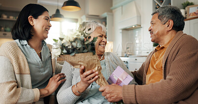 Buy stock photo Daughter, flowers and senior parents with birthday gift for love, care or celebrate mothers day in home. Family, happy people and giving bouquet present, congratulations or excited at special event