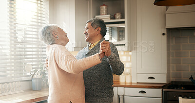 Buy stock photo Senior couple, dancing and smile in kitchen with love, bonding and celebration for anniversary. People, man and woman with holding hands, retirement and happy for memory in relationship at apartment
