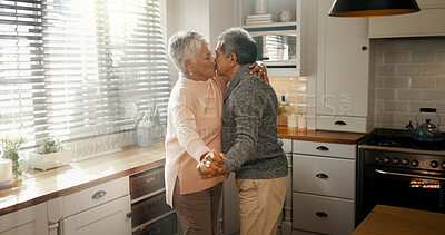 Buy stock photo Kiss, dance and senior couple with love in home for healthy relationship, connection or holding hands. Retirement, man and woman moving with romance music to celebrate marriage anniversary in kitchen