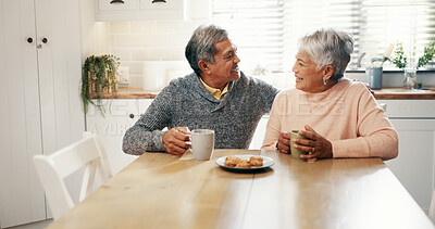 Buy stock photo Home, hug and old couple with coffee for laughing, bonding and biscuits for breakfast in retirement. Senior people, woman and man with happiness for love, funny joke and cookies with tea in kitchen