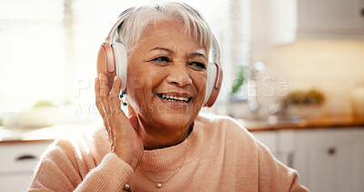 Buy stock photo Smile, headphones and relax with old woman in kitchen for streaming, audio subscription and podcast. Happiness, retirement and music with senior person in home for sound, listening and radio