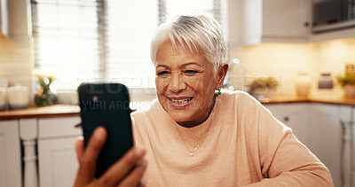 Buy stock photo Phone, video call and senior woman in home with communication, networking or contact. Happy, technology and elderly female person with cellphone for virtual conversation on mobile app in kitchen.