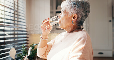 Buy stock photo Thinking, senior woman and drink water for hydration, reflection and remember past life in kitchen. Elderly person, glass and refreshing beverage with thoughts, memory and future wellness at house