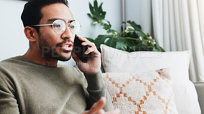 Buy stock photo Phone call, upset and man on sofa in home for communication, social networking and talking. Living room, crisis and frustrated person on smartphone for contact, online conversation and connection