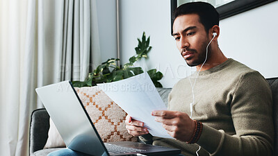 Buy stock photo Home, earphones and man on laptop with documents on sofa for online course, lesson and business seminar. Remote work, living room and person on computer listening to podcast, audio or read transcript