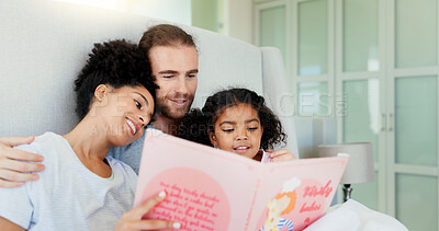 Buy stock photo Parents, girl and reading book in bed for story, happy and learning with care, embrace or language in home. Father, mother and daughter with hug, love or smile for bonding at interracial family house