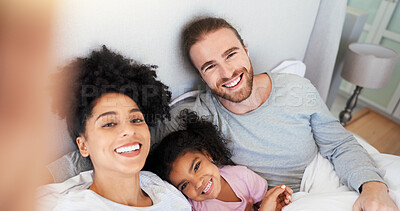 Buy stock photo Parents, girl and selfie in bed, smile and portrait with care, memory and post on web in morning at house. Man, woman and happy with photography, bonding and social media in interracial family home