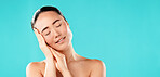 Closed eyes, skincare and Asian woman with cosmetics, dermatology and beauty on blue studio background. Person, mockup space and model with texture, wellness and natural glow with healthy skin