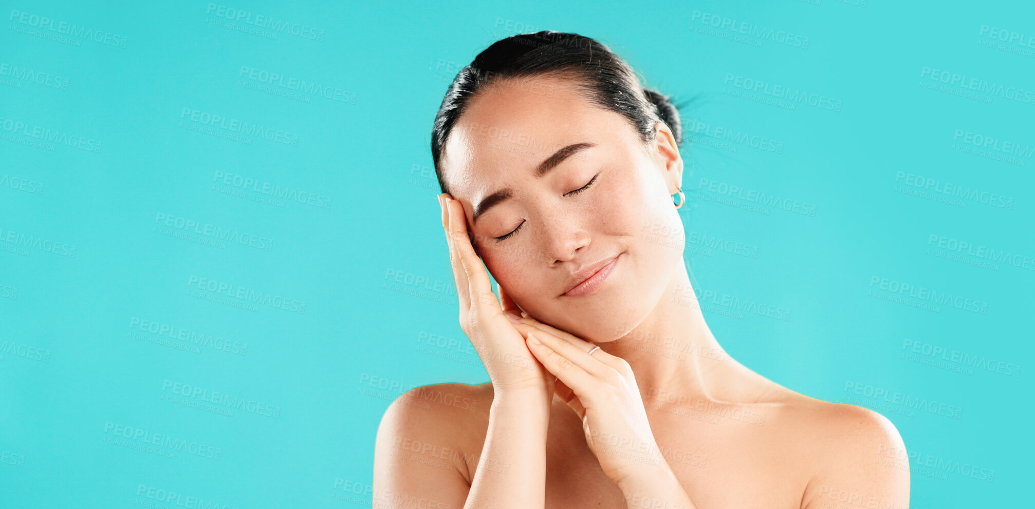 Buy stock photo Eyes closed, skincare and Asian woman with cosmetics, beauty and healthy skin on blue studio background. Person, mockup space and model with texture, wellness and natural glow with dermatology