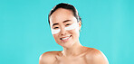 Studio, asian woman and skincare with eye patches in portrait, facial treatment or collagen with smile. Happy, female person and model with skin gel for beauty, cosmetics or mockup by blue background