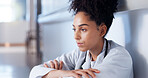 Doctor, sad and thinking on hospital floor for healthcare fail, medical challenge and bad news. African woman, stress and disappointed professional for clinic loss, grief and overwhelmed in corridor
