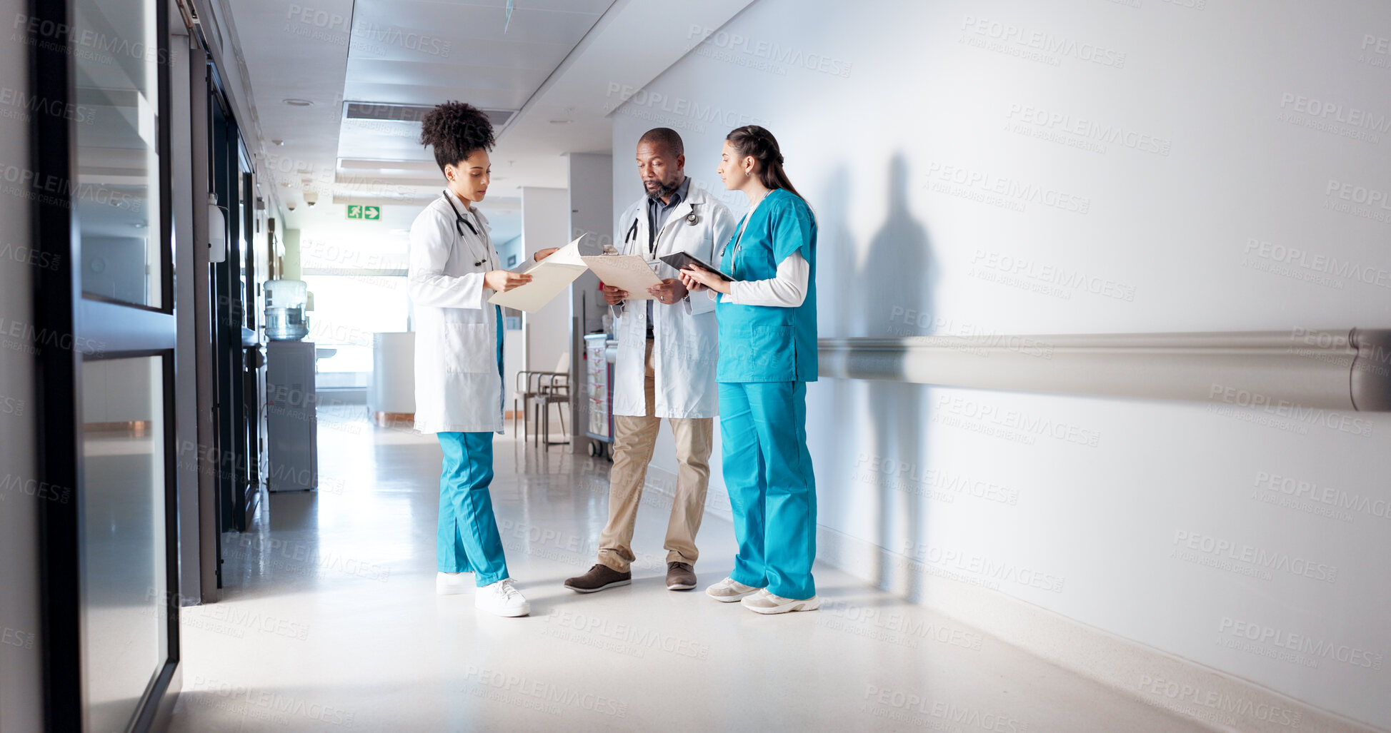 Buy stock photo Hospital, meeting and doctors in hallway with notes for consulting, patient results and planning. Healthcare, collaboration and man and women with medical service, diagnosis and help in clinic