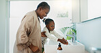 Hygiene, helping and black mother with child for washing hands in bathroom for learning. Happy, teaching and African mom with girl for cleaning skin for prevention of bacteria, dirt or dust in home.