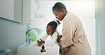 Hygiene, helping and black mother with kid for washing hands in bathroom for learning. Happy, teaching and African mom with girl for cleaning skin for prevention of bacteria, dirt or dust in home.