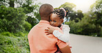 African father, child and hug outdoor for love, care and bonding together with family for connection. Parent, girl and carrying kid at park with papa for support, trust and affection with daughter