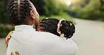 Mother, kid and hug outdoor for love, care or bonding together with family for connection. African parent, girl and embrace child at park with mama for support, trust or reunion with daughter on road