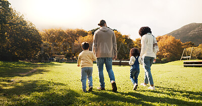 Buy stock photo Walking, back and holding hands with family in park for bonding, support and autumn season. Love, nature and adventure with parents and children outdoors for travel, care and vacation together