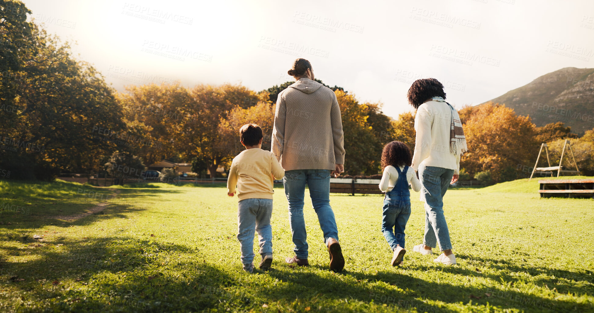 Buy stock photo Walking, back and holding hands with family in park for bonding, support and autumn season. Love, nature and adventure with parents and children outdoors for travel, care and vacation together