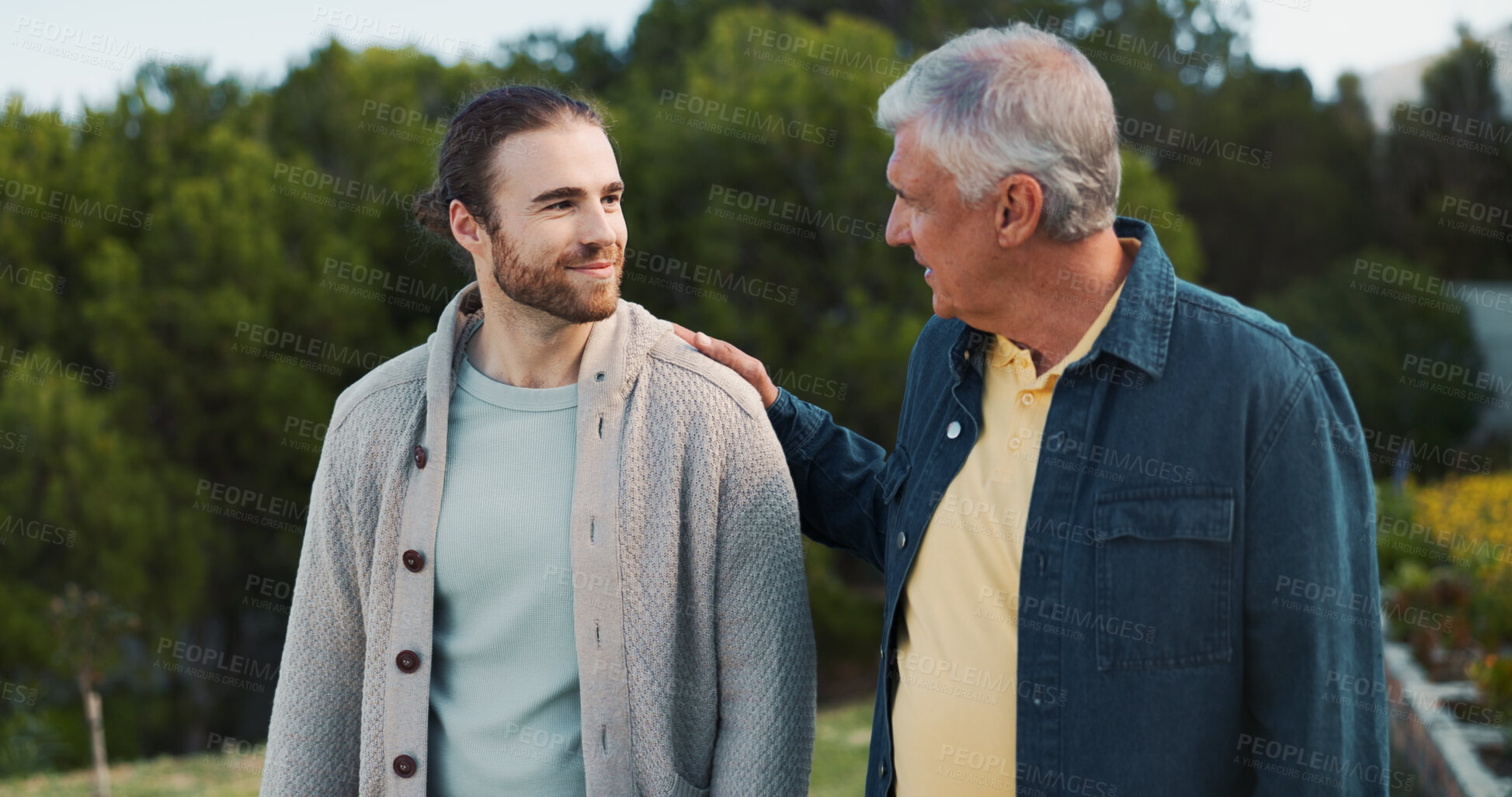 Buy stock photo Father, son and walk with comfort at park for family reunion, bonding together and summer vacation. Smile, senior dad and men with discussion, support and travel journey with parent advice in nature