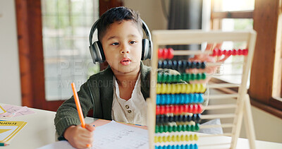 Buy stock photo Home, maths and child with headphones, learning and listening to podcast for education and abacus. Studying, student and kid with audio for homework, growth and development with knowledge or numbers