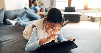 Buy stock photo Home, child and girl with tablet for game, entertainment and online fun with technology on sofa. Couch, parents and happy kid with tech for application, streaming and scroll on website in living room