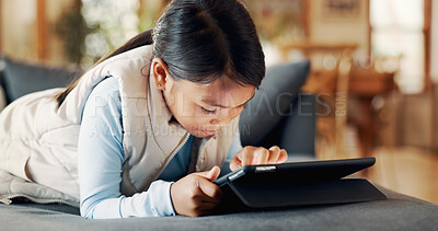 Buy stock photo Sofa, child and girl with tablet for game, entertainment and online fun with technology at home. Couch, relax and female kid with digital for application, streaming and scroll on web in living room