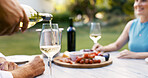 Hand, pour wine and couple on date for romance, anniversary celebration and breakfast picnic. Senior people, champagne and charcuterie board, bonding and relationship commitment in backyard at house
