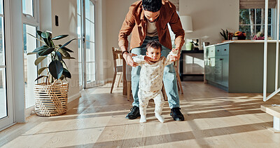 Buy stock photo First steps, learning or walking with dad and toddler in home for child development or growth. Balance, mobility support with single parent teaching baby how to move in apartment for motor skills