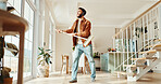Broom, energy and music with man in home for chores, responsibility or spring cleaning. Headphones, sing and sweeping with happy person in apartment for housekeeping, listening or radio streaming