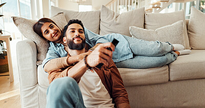 Buy stock photo Relax, couple and watching tv in home, bonding and comfortable in living room with smile, hug or sofa. Resting, woman and man with remote for entertainment, people and streaming movies in lounge