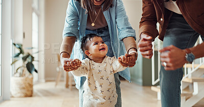 Buy stock photo First steps, success or walking with parents and toddler in home for development or growth. Balance, encourage or support with mom and dad teaching child how to move in apartment for motor skills