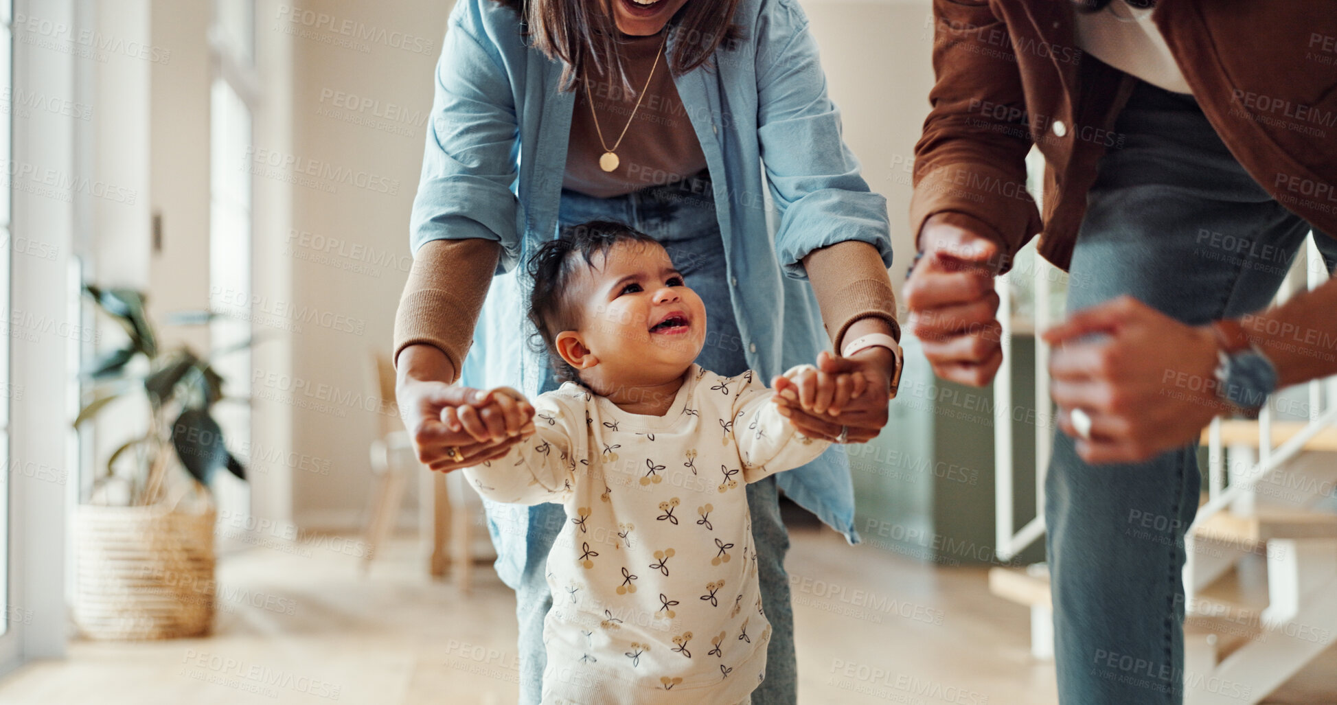 Buy stock photo First steps, success or walking with parents and toddler in home for development or growth. Balance, encourage or support with mom and dad teaching child how to move in apartment for motor skills