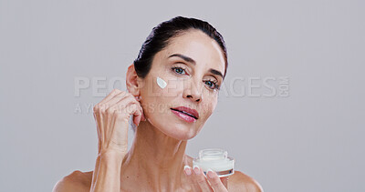 Buy stock photo Portrait, beauty and woman with face cream in studio for skin moisturizer, wrinkle reduction or hyaluronic acid. Mockup space, mature person or spf sunscreen product for hydration on white background