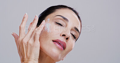 Buy stock photo Skincare, beauty and woman with face cream in studio for anti aging treatment, wrinkle reduction and retinol. Mockup, mature person and cosmetics product application for hydration on white background