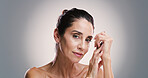 Natural skincare, portrait and mature woman with beauty, dermatology and treatment for anti aging. Model, confident face and cosmetics, aesthetic or skin texture for glow on gray studio background