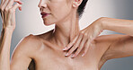 Skincare, hands and glow of body, studio and treatment for shine of skin, antiaging and cosmetics for woman. Gray background, model and wellness with dermatology for person, beauty and routine