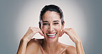 Natural skincare, portrait and woman laugh with glow, touch and collagen treatment for anti aging. Mature model, happy face and cosmetics, dermatology and shine for beauty on gray studio background