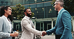 Business people, handshake and meeting outdoor in city for discussion, introduction or deal. Happy men, woman or corporate partners together for onboarding, agreement or networking for urban work