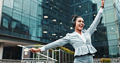 Buy stock photo Business, woman and dancing with headphones in city for music playlist, celebration and streaming audio. Excited, person and energy outdoor for sound subscription, listening to radio and work break